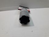 a close up of a black pipe on a white surface