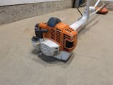 an image of a small lawn mower in a garage