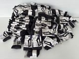 a pile of black and white socks on a white table