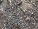 a metal plaque with a picture of a man on a horse