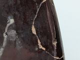 a close up of a brown vase with a white background