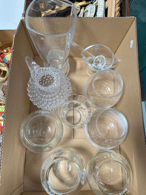 a box of empty glassware sitting on a table