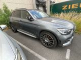mercedes gle parked in a parking lot next to a building