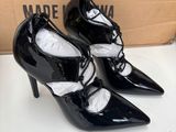 a close up of a pair of black high heeled shoes on a table