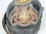 a black helmet with a gold cross on it