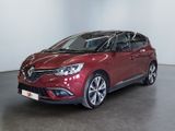 une voiture rouge garée dans une pièce aux murs blancs