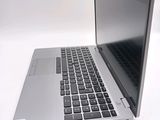 a silver laptop with a black keyboard on a white surface