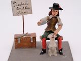 a figurine of a woman sitting on a bench with a dog
