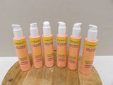 six bottles of sunscreen lotion sitting on top of a wooden board