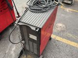 two welding machines that are sitting in the parking lot