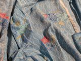 an image of a blue dress with flowers on it