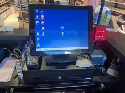 a computer monitor sitting on top of a desk in a store