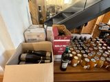 many bottles of wine and jars of honey on a table