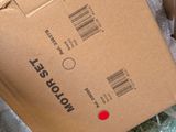 a cardboard box with a red button on top of it