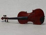 a red violin that is sitting on a white surface
