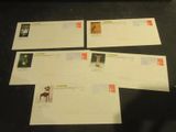 three envelopes with stamps on them sitting on a table