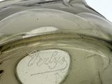 a green glass vase with a label on it