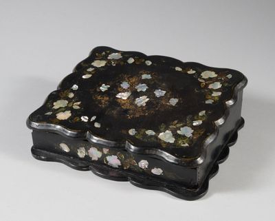 an image of a black and gold box with flowers on it