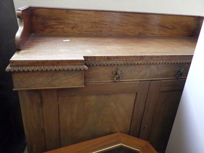 a wooden cabinet with a mirror on top of it