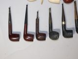 a lot of different types of smoking pipes on the table