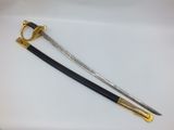 two swords with gold and black handles on a white surface