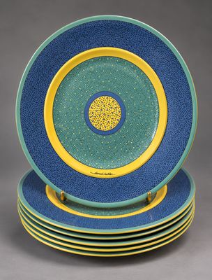 four blue and yellow plates stacked on top of each other