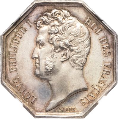 une vieille pièce d'argent sur laquelle figure le portrait d'un homme