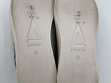 a pair of shoes with a white sole on a white surface