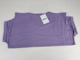 a close up of a purple t - shirt with a tag on it