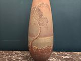 two vases sitting on a table with a wall in the background
