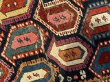 a close up of a colorful rug with a cat on it