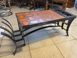 a coffee table with chairs around it in a room