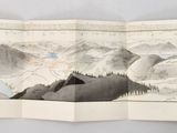 une photo d'un livre fermé sur lequel figure une image de montagnes