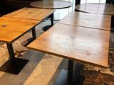 two tables that are sitting in front of a window