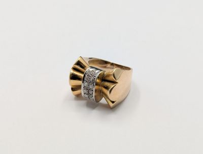 a close up of a gold ring with diamonds on a white surface