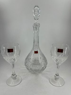 two wine glasses and a decanter on a white background