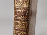 an old book sitting on top of a white surface