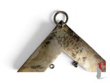 a close up of a metal object on a white surface