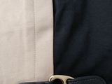 the belt is attached to the back of a jacket