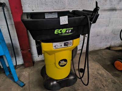 a yellow and black machine that is sitting in a garage