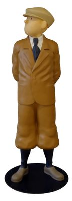 a figurine of a man in a suit and hat