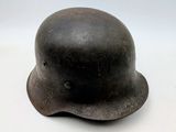 an old helmet is sitting on a white surface with a white background