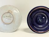 two blue and white plates sitting next to each other