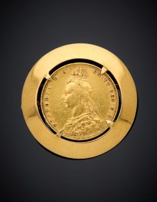 a close up of a gold coin with a crown on it