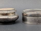 pair of silverplated jars with lids on a gray surface
