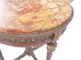 a marble top table with a wooden base and legs