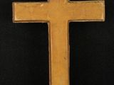 an image of a wooden cross hanging on a black background
