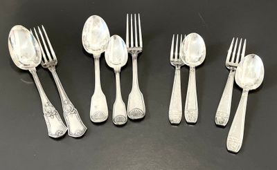 six silver spoons and six forks are lined up on a black surface