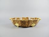 a close up of a bowl on a table with a gray background