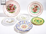 cinq assiettes aux motifs variés, posées sur un fond blanc